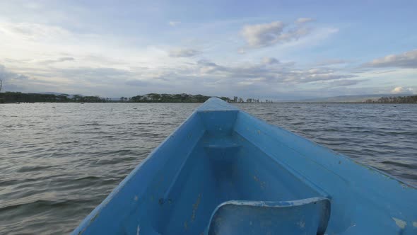 Blue boat sailing on Lake Naivasha alt