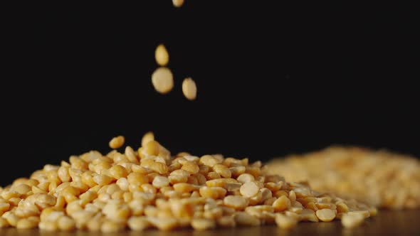 SLOW MOTION: Yellow Peas Pouring Onto A Table - Close Up alt