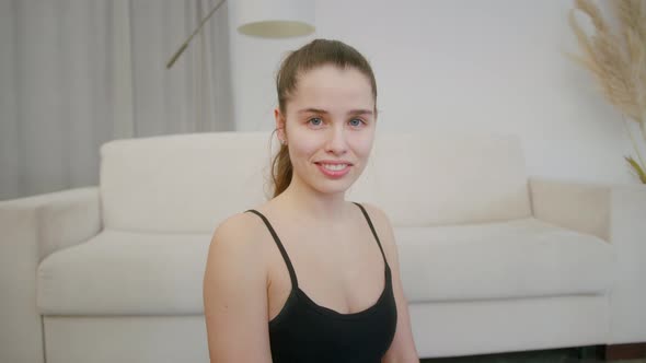 Young Beautiful Woman After Training at Home Looking at Camera Indoor alt