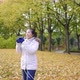 Asian woman taking a photo of view around the park in Autumn - VideoHive Item for Sale