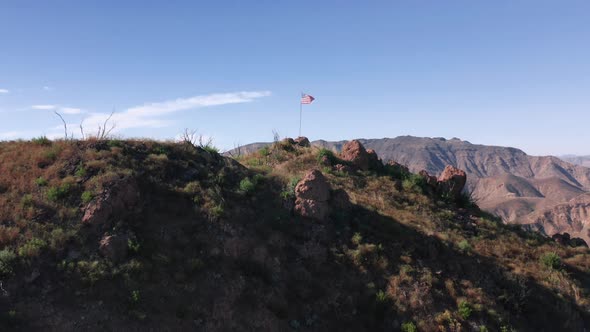 Camera Is Rising Up Above the USA Patriotic Flag Set Up in the Mountains.  alt