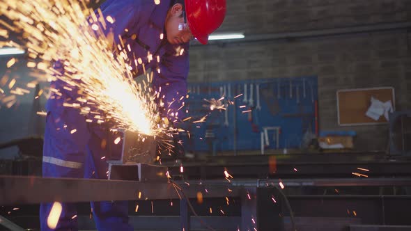 asian male technician worker in a safty uniform wear welders leathers alt
