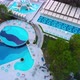 Flight Over the Beach with Umbrellas Towards the Pool in a Luxury Hotel - VideoHive Item for Sale