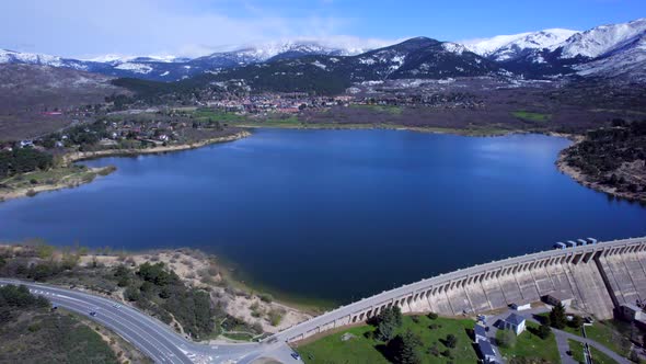 Incredible high angle aerial view over the Reservoir and Dam of Navacerrada in Spain. alt