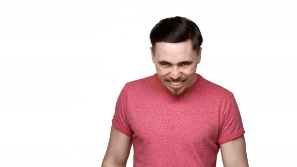 Portrait of Crazy Man 30s Grinning with Mad Gaze and Looking Scary Isolated Over White Background alt
