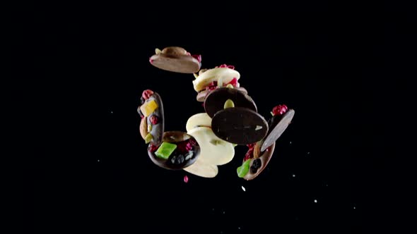 Flying and Falling Luxurious Sweets Made of White and Dark Chocolate Slow Motion