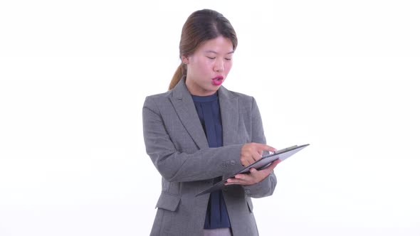 Happy Young Asian Businesswoman Talking While Holding Clipboard alt
