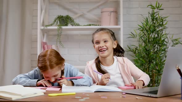 Two Little Children Girl Using Laptop for Doing School Tasks at Home