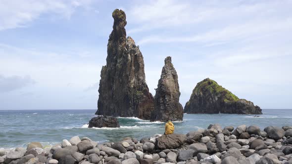 Woman looking at Ribeira da Janela islet in Madeira alt