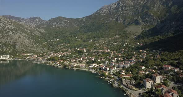 Risan in Montenegro, filmed from the air with mountains behind and the bay of Kotor in front alt