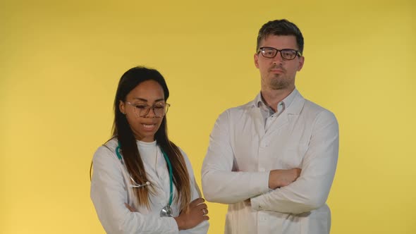 Multiracial Woman and Man in Lab Coat Showing That They Are Agree with Something alt