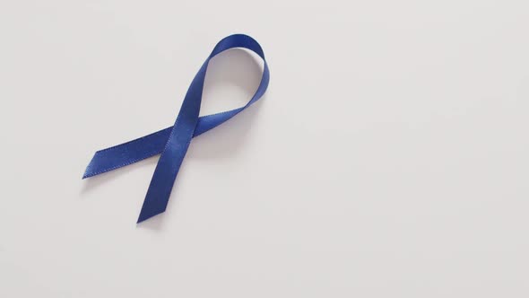 Video of dark blue colon cancer ribbon on white background alt