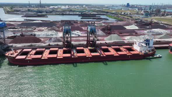 Cranes Unloading Commodities From a Bulk Carrier Ship at Port alt