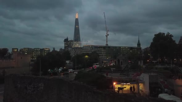 Aerial Drone Rising Above Wall Reveals The Shard Skyscraper in London UK Evening Night alt