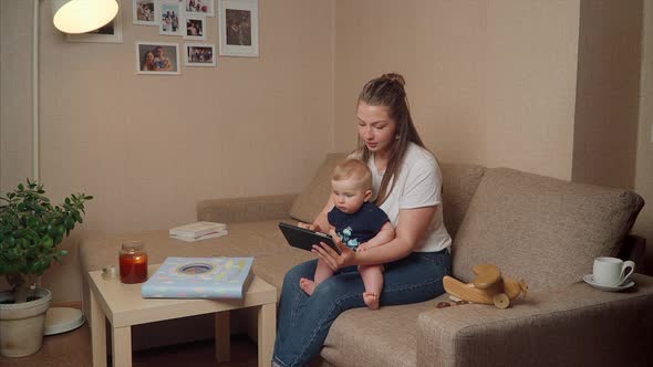 Mother And Baby Look In Tablet
