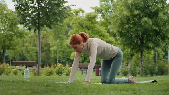Woman stretching back muscles, outdoor. alt