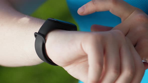 Hands of Fat Woman Runnner Using Fitness Bracelet alt