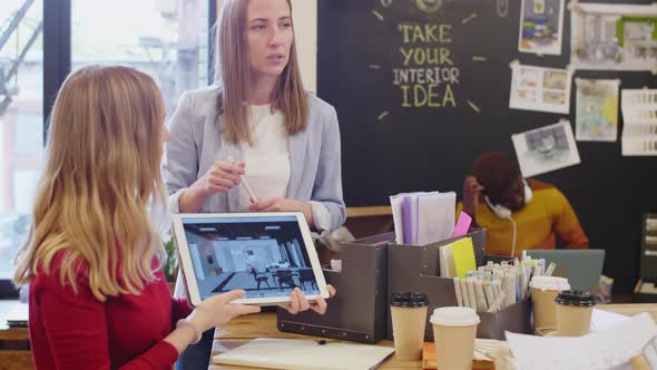 Female Designers Presenting Interior on Digital Tablet