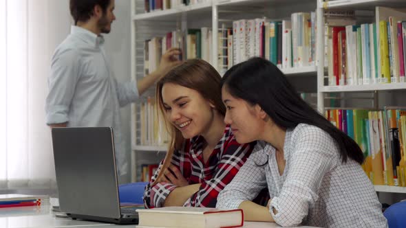 Two Girl Study on Laptop at the Library alt