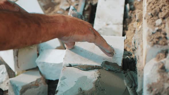 Construction Worker or Mason Laying Bricks and Creating Walls. Bricklayer Laying Bricks To Make a alt