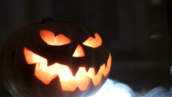 Carved Halloween Pumpkin with Lights and Smoke.