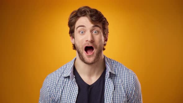 Young Casual Man Surprised and Excited of Something Yellow Background alt