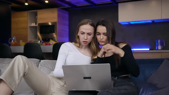 Female Friends which Spending their Joint Free Time Together Using Computer alt