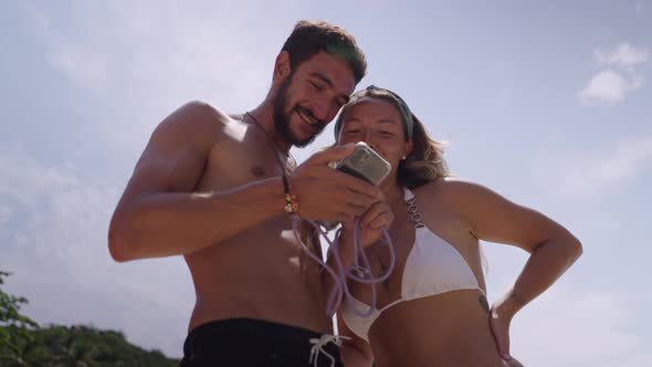 A Video of a Couple Enjoying Each Other Company While Standing on Beach alt