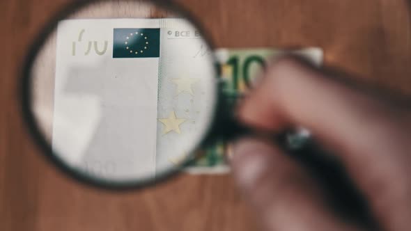 One Hundred Euro Under Magnifying Glass alt