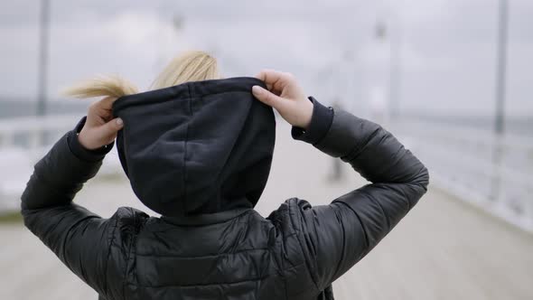 Woman Putting On The Hood