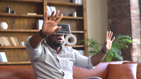 An AfricanAmerican Man Wearing VR Headset at Home alt