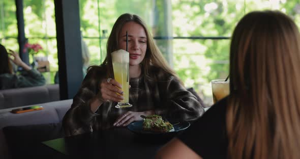 Woman Drinking Cocktail in Restaurant