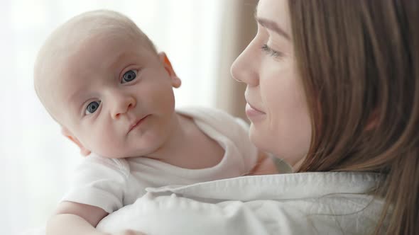 Caucasian Woman Holding on Hands Her Newborn Son alt