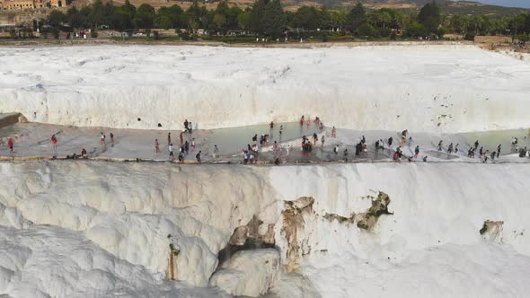 Visitors and Tourist People Walks Pamukkale's Calcium Carbonate Travertines alt