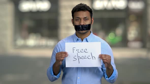 Young Man is Silenced with Duct Tape Over His Mouth alt