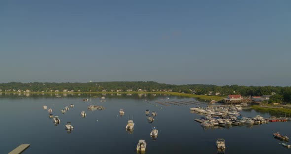 Forward Slow Pan of Boats Anchored on Oyster Bay on a Sunny Day in Long Island alt
