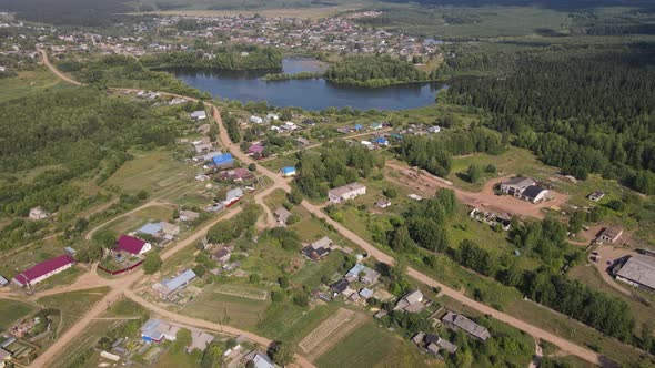 Aerial View of Lake Surrounded By Trees and Country Houses