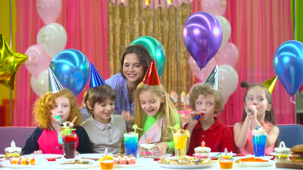 Kids in Colorful Hats Celebrating Birthday with Mother and Fiends alt