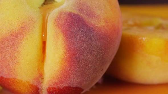 Drop of Juice Flows Over the Peach. Velvet Peach, Close-up.