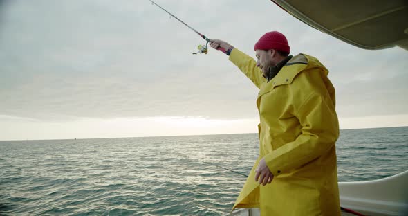 A Man on a Boat is Fishing in the Open Sea