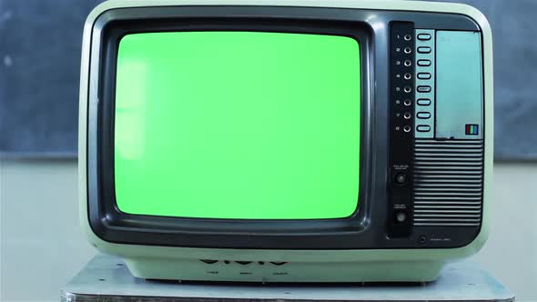 Retro TV Set turning on Green Screen with Color Bars in Classroom. Dolly In. 4K Version. alt