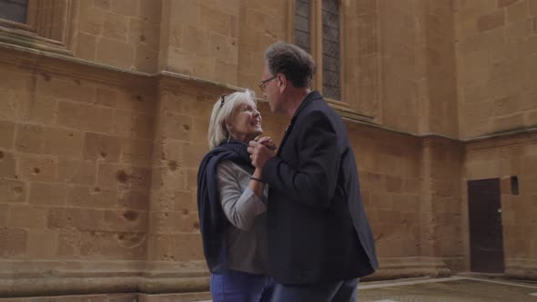 Senior couple dancing outdoors