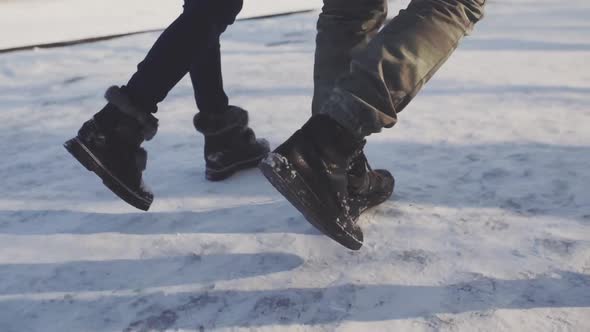 Feet Walking in the Snow with Tracking Shoes alt