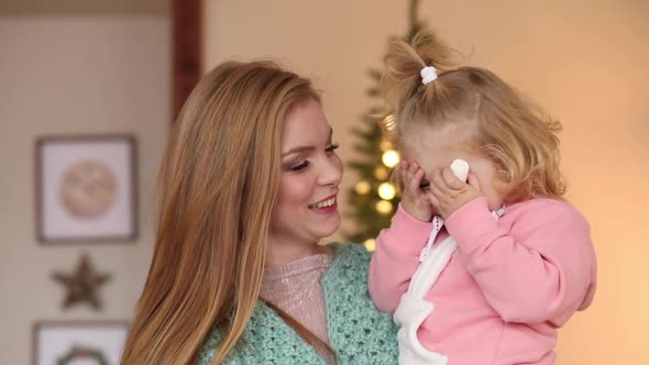 Mother and Daughter Sending Kisses at Camera.