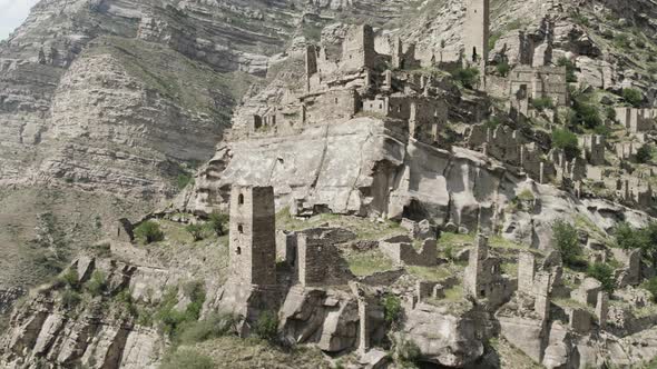 Rock cliff with old towers and constructions alt