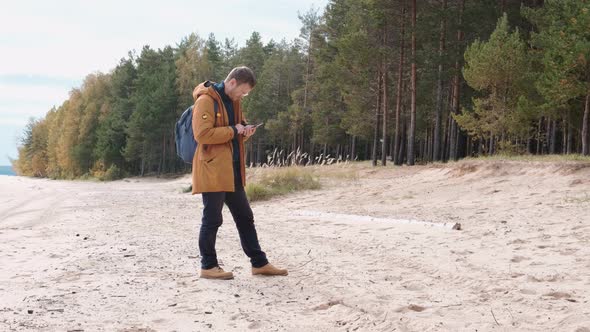 Portrait of a Caucasian Man with a Smartphone in His Hand