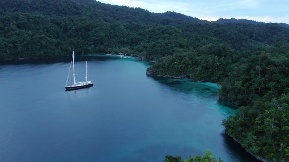 Aerial View Of Triton Bay: Boat On Turquoise Sea And Green Tropical Trees In Kaimana Islands alt