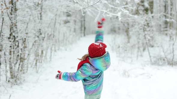 Child Girl in Winter Playing in Snow Into Park Outdoor