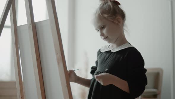 Little Girl Paint A Picture On Easel