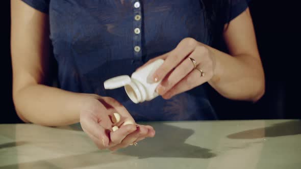 Hand of young woman with many pills. Concept of medicine alt